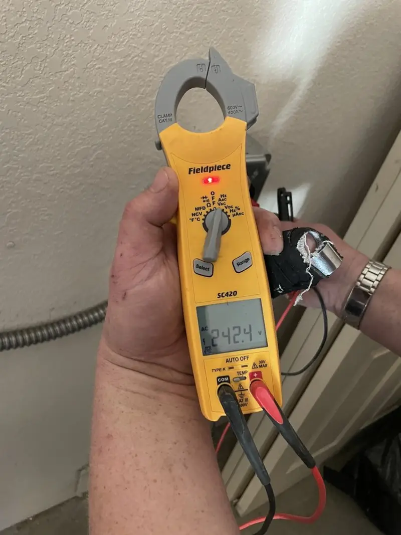 Voltage testing with clamp meter during Outlet Installation in Cambridge